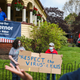 A bystander argues with protestors outside the home of Massachusetts Governor Charlie Baker